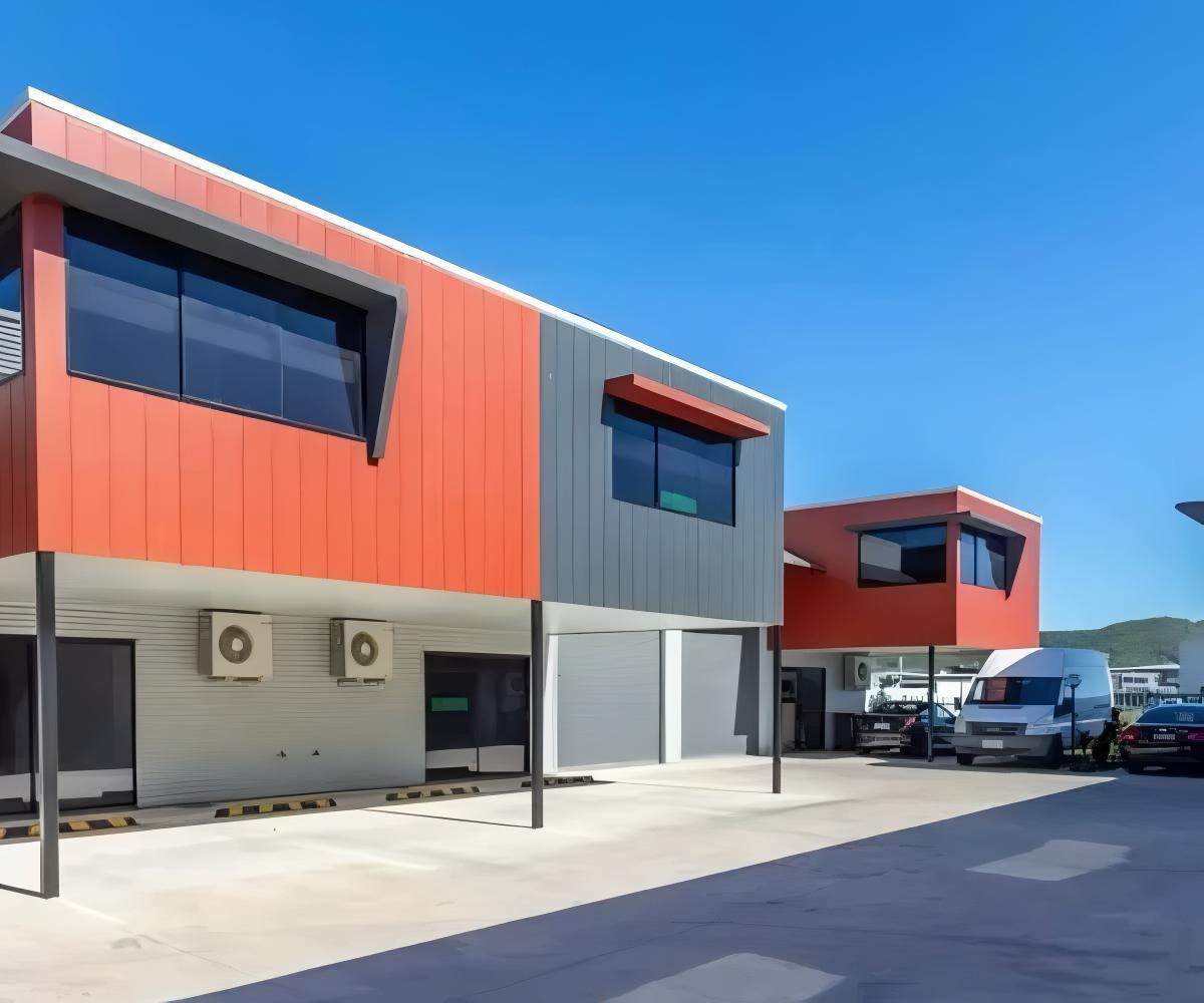 A Row of Buildings With Cars Parked in Front of Them — O'Brien Painting Contractors in Warana, QLD