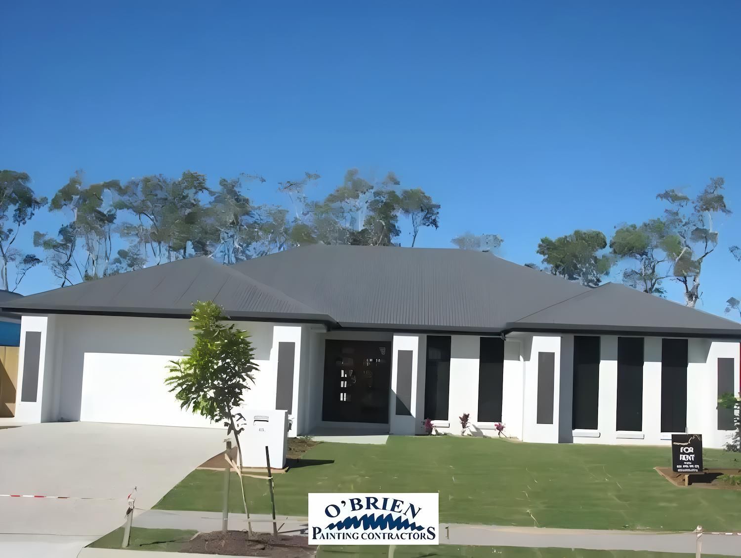 A Large Gray and White House With a Sign That Says 'o'brien' on It — O'Brien Painting Contractors in Alexandra Headland, QLD