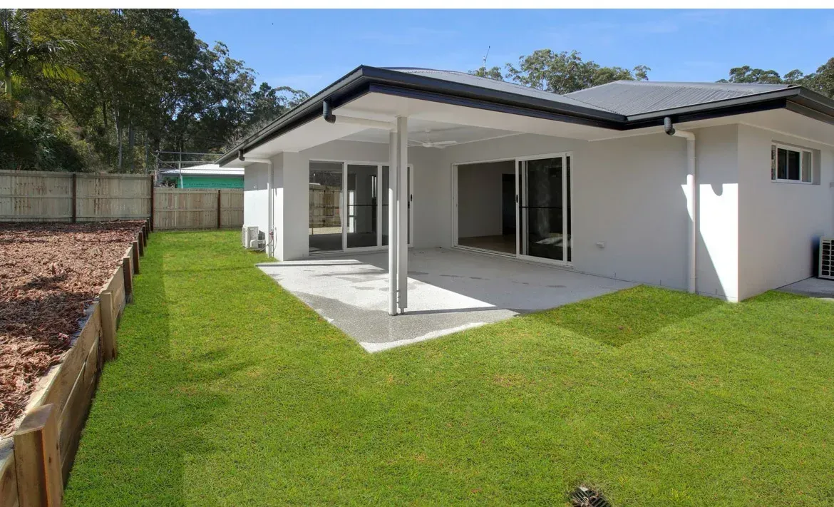 A White House With a Large Lawn in Front of It — O'Brien Painting Contractors in Alexandra Headland, QLD
