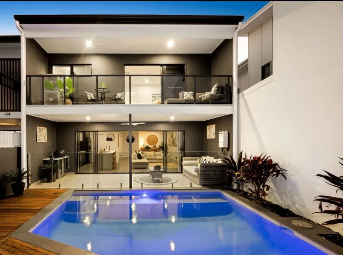 A Large House With a Swimming Pool in Front of It — O'Brien Painting Contractors in Alexandra Headland, QLD