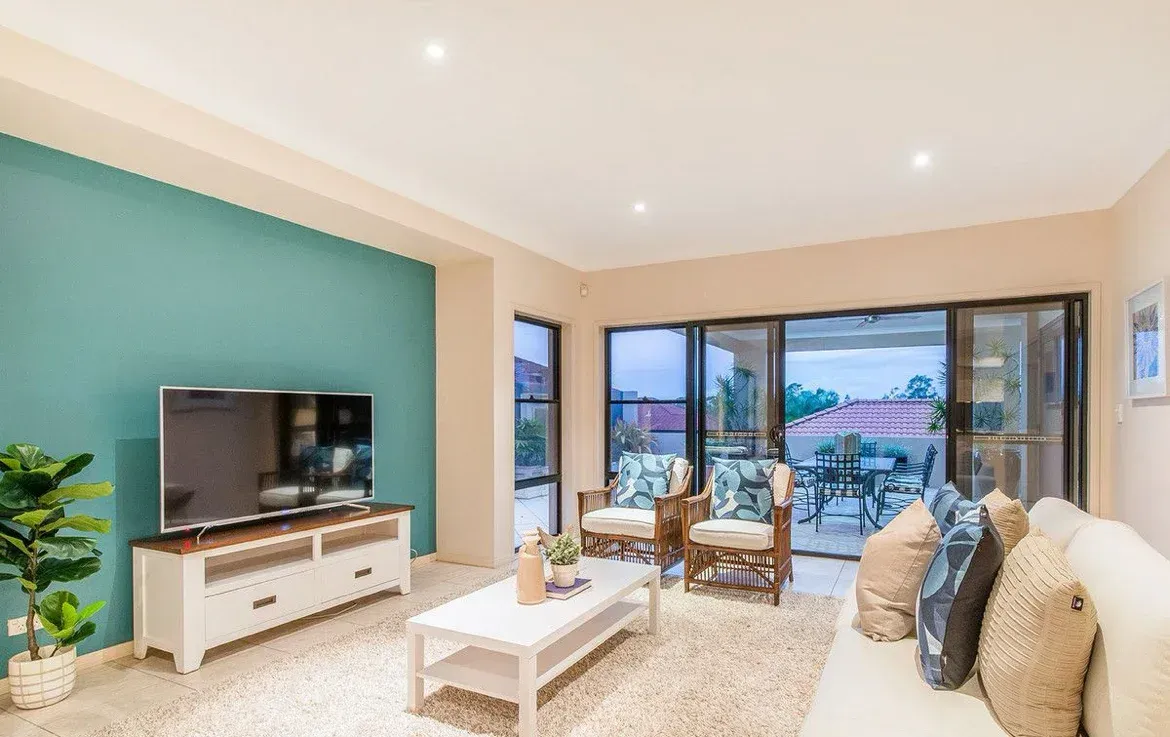 A Living Room With a Couch, Chairs, Coffee Table and Television — O'Brien Painting Contractors in Alexandra Headland, QLD