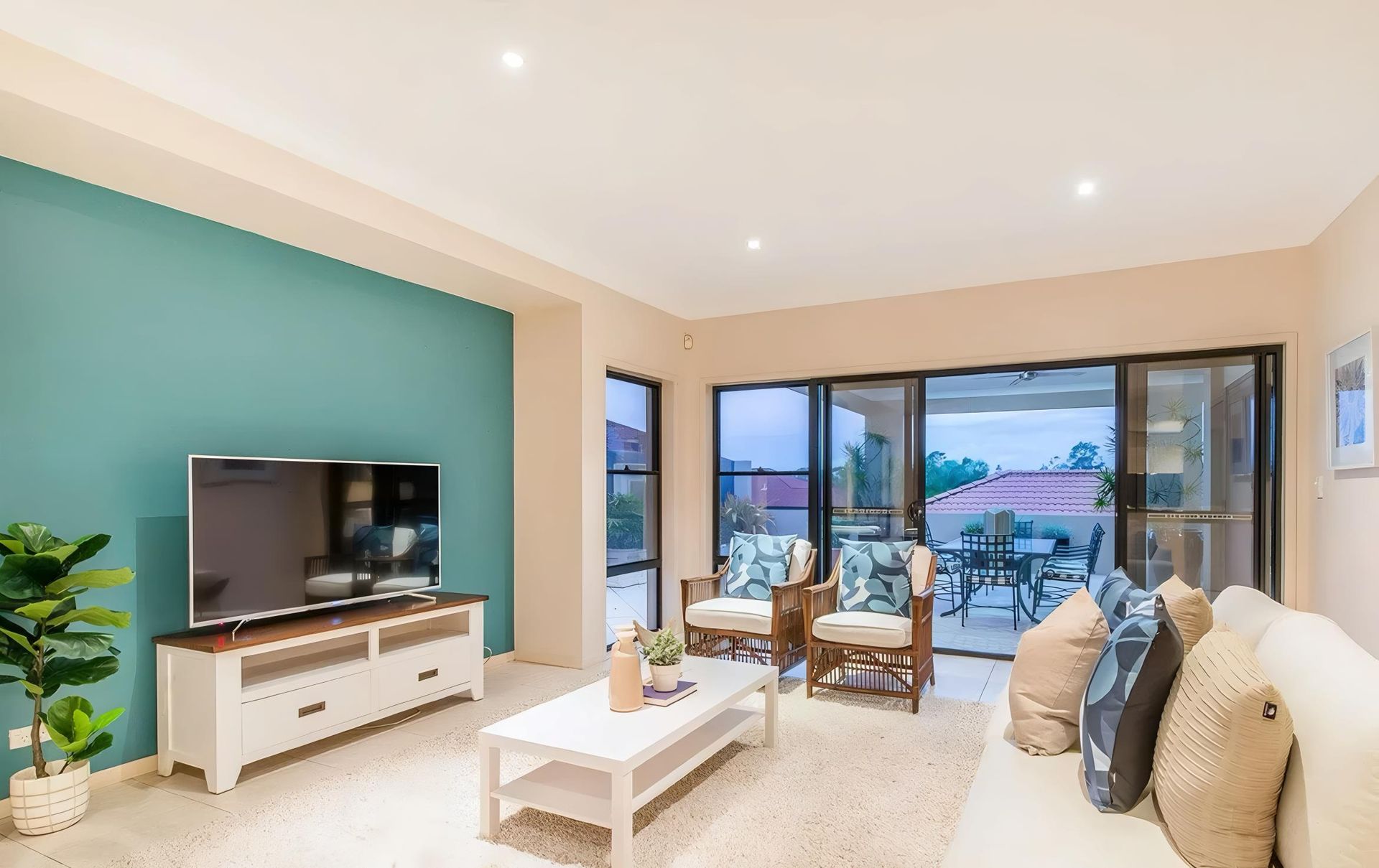 A Living Room With a Couch, Chairs, Coffee Table and Television — O'Brien Painting Contractors in Coolum, QLD
