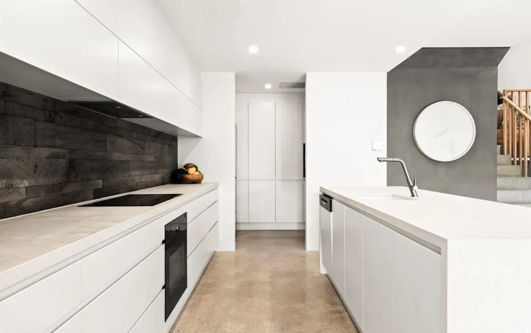 A Kitchen With White Cabinets, a Sink, a Stove, and a Mirror — O'Brien Painting Contractors in Alexandra Headland, QLD