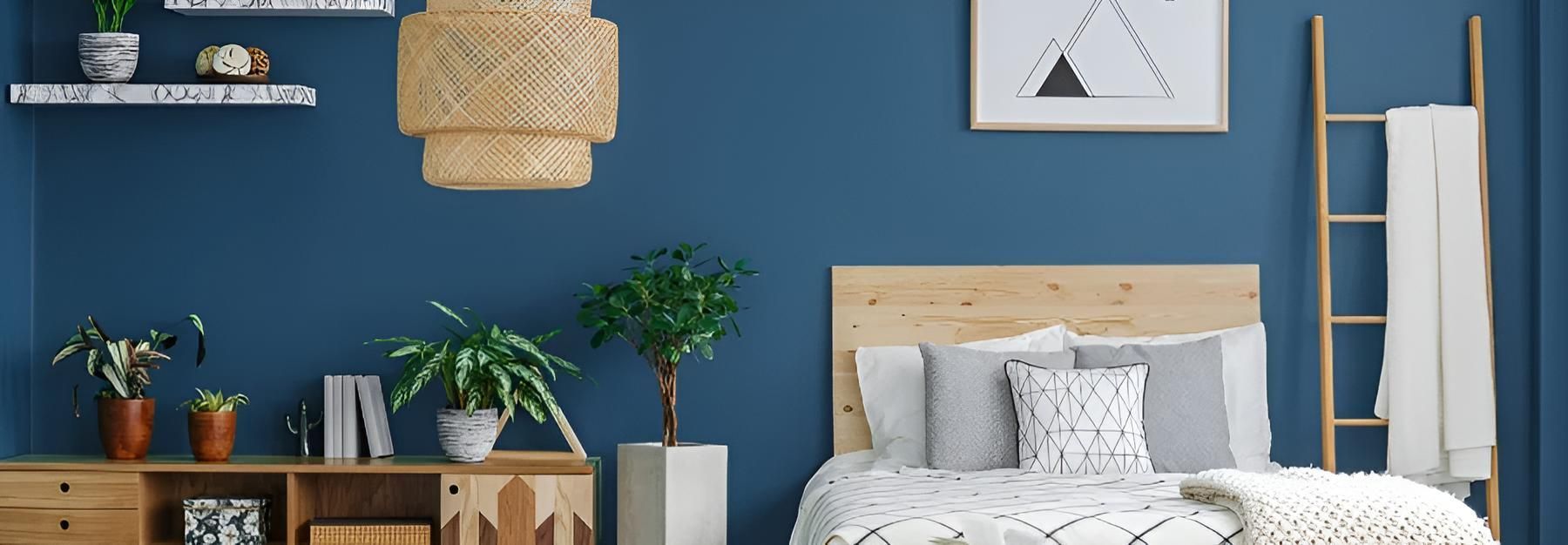 A Bedroom With Blue Walls and a Bed — O'Brien Painting Contractors in Alexandra Headland, QLD