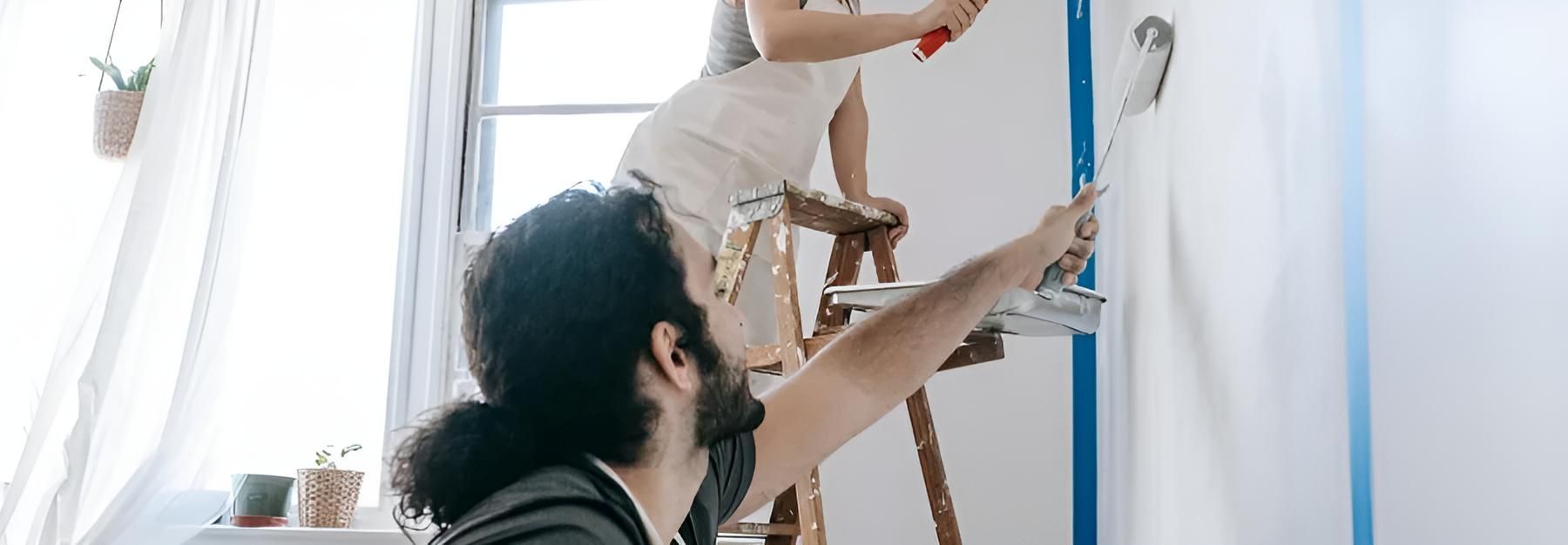 A Man and a Woman Are Painting a Wall Together — O'Brien Painting Contractors in Alexandra Headland, QLD