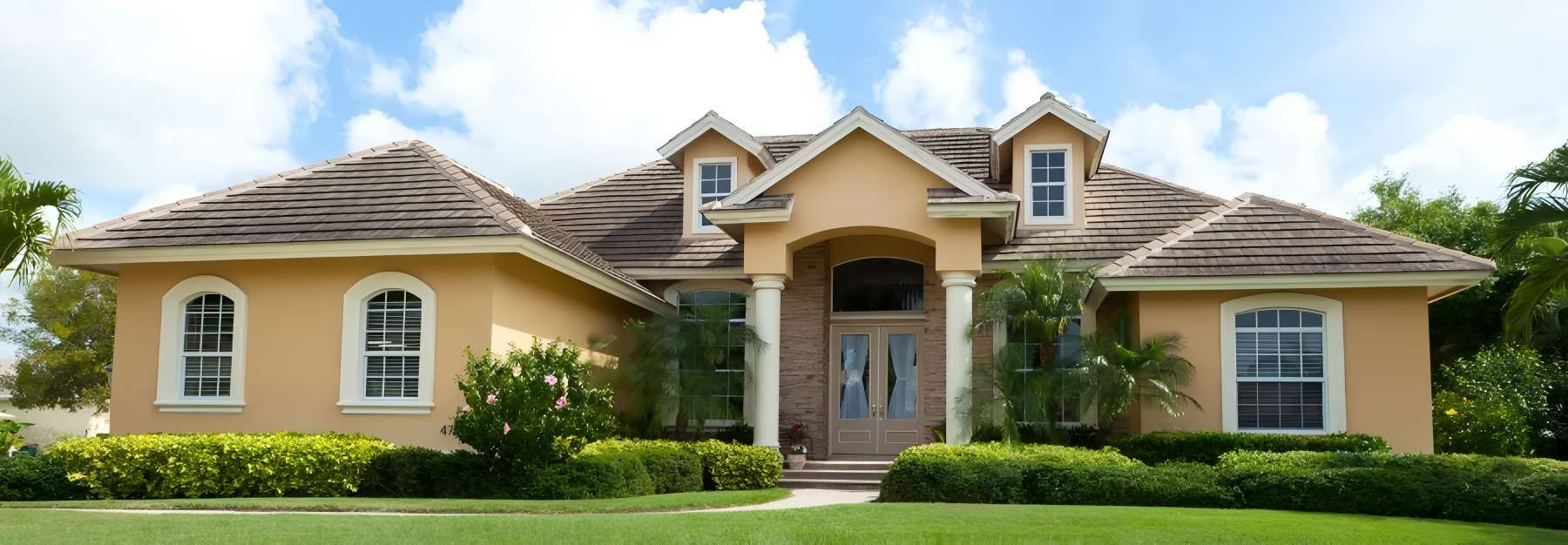 A Large House With a Lush Green Lawn — O'Brien Painting Contractors in Alexandra Headland, QLD