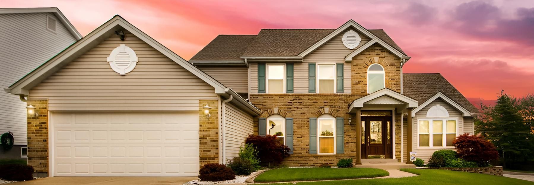 A Large House With a Garage and a Sunset in the Background — O'Brien Painting Contractors in Alexandra Headland, QLD