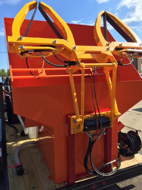 Dumpster Cleaning equipment orange hopper with yellow lifters