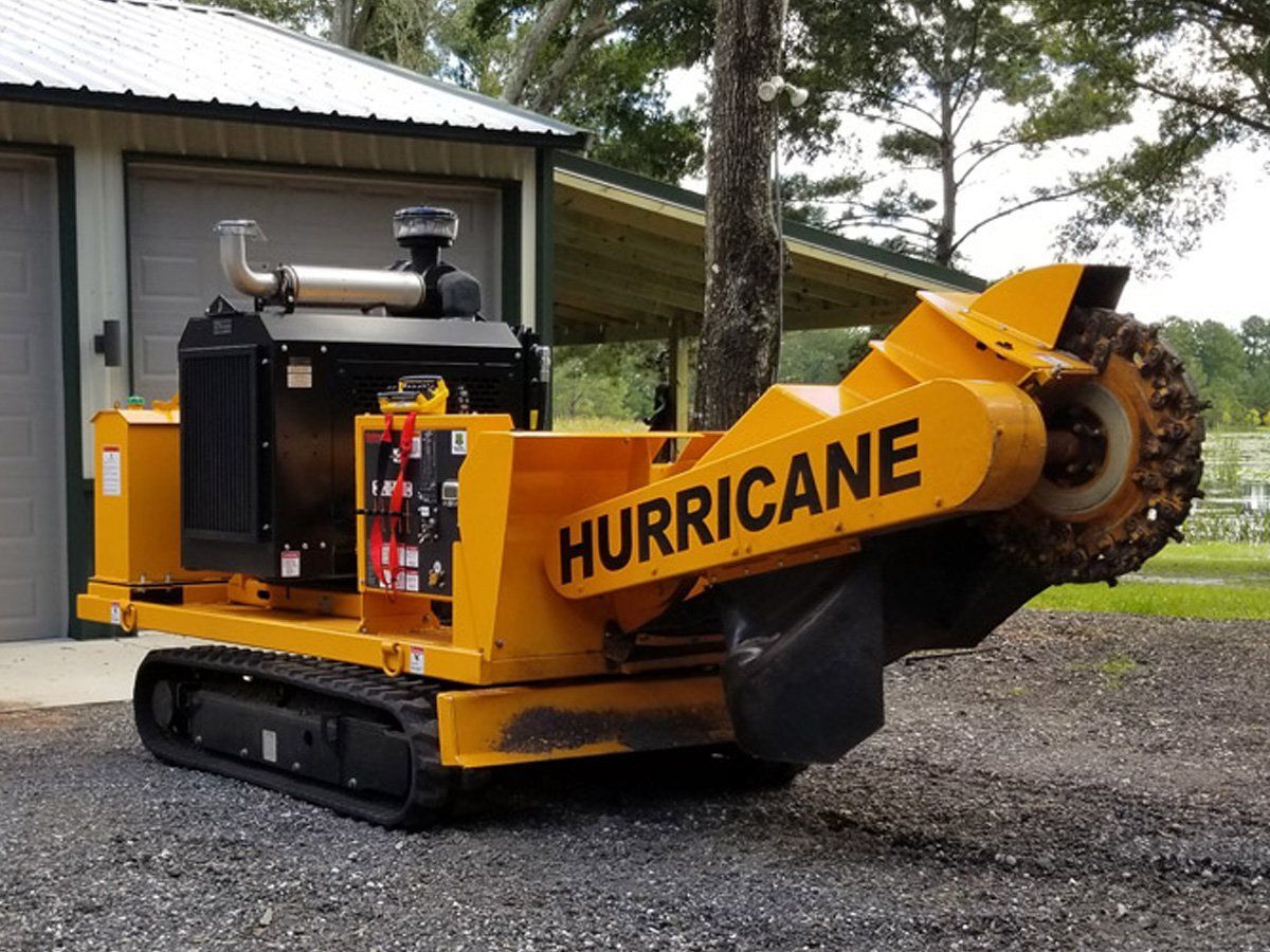 Yellow Hurricane stump grinder on tracks, outdoors.