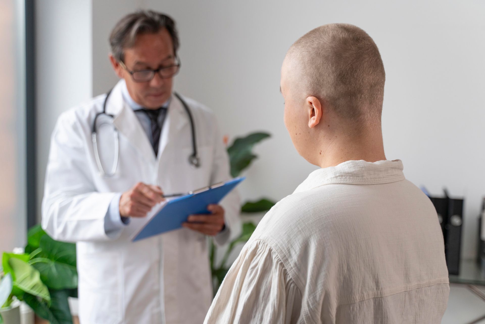 A doctor is talking to a patient with cancer in a hospital.