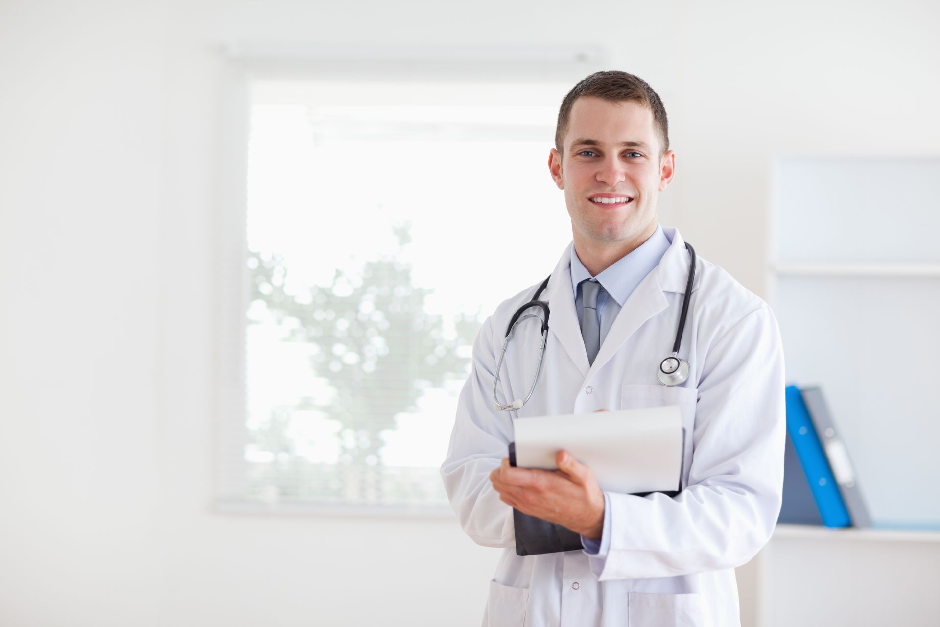A person is tying a surgical gown around their waist.