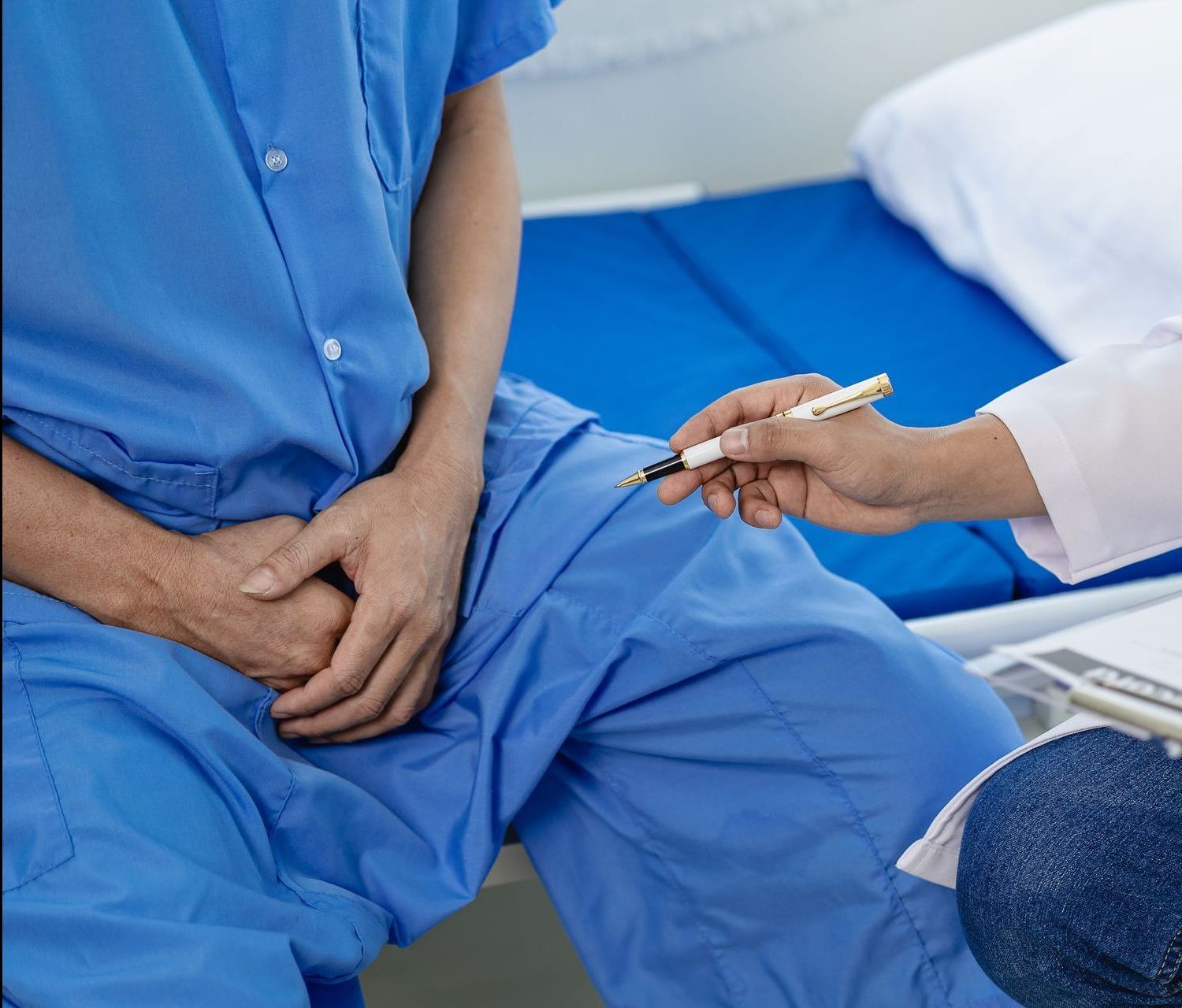 A doctor is talking to a patient in a hospital bed.