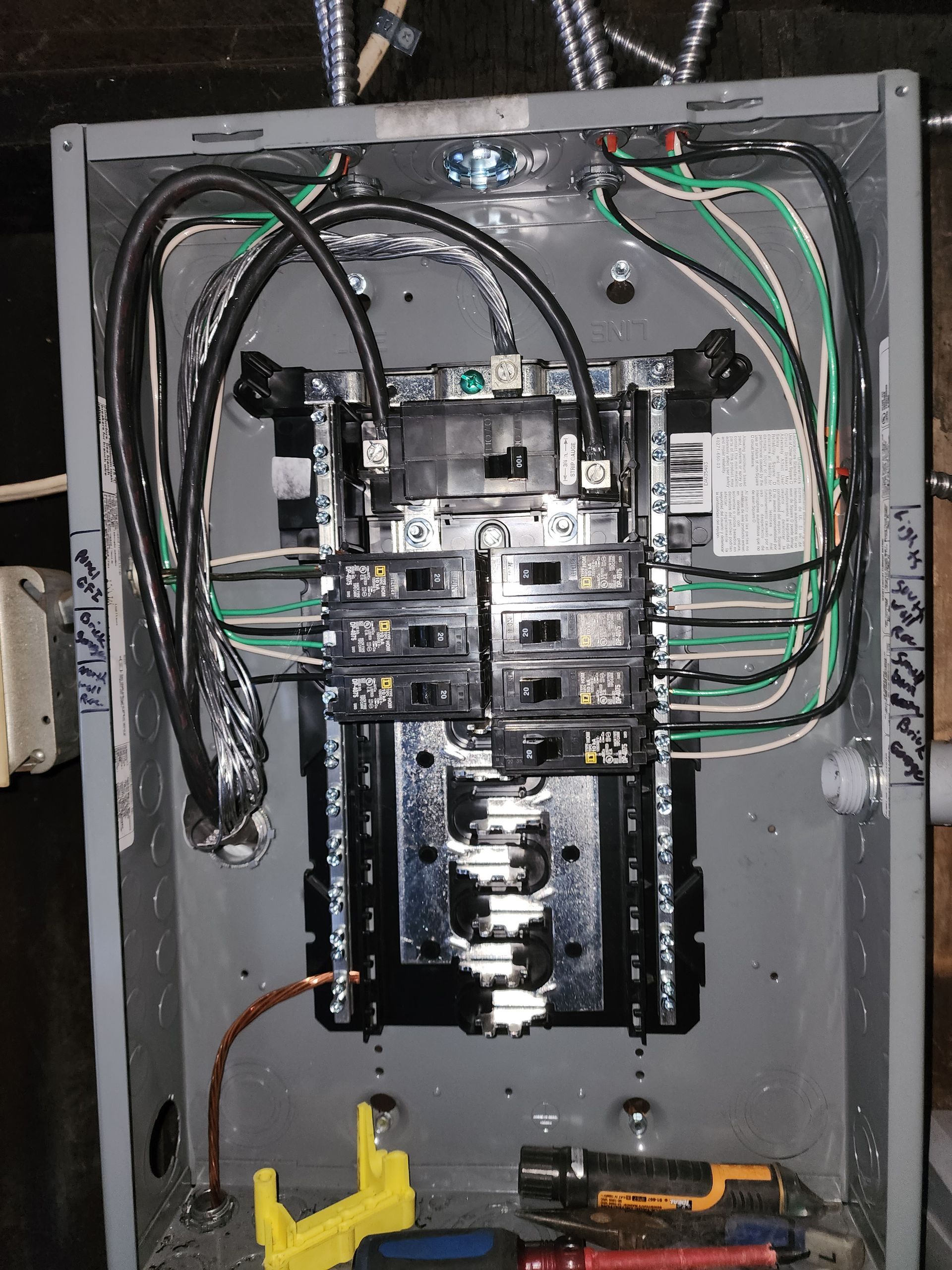 Anesthesia equipment hanging from ceiling in a clinical setting; white lights and beige walls.