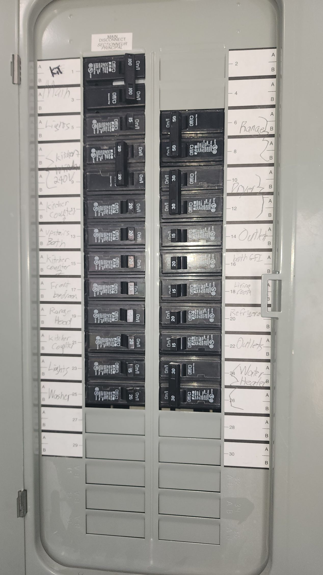 Apartment complex entrance with a gate, parking markings, and a white van parked nearby.