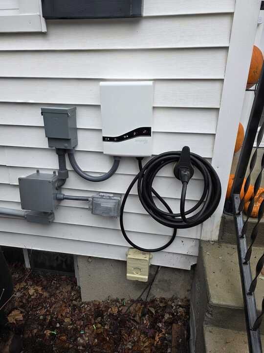 Television mounted on a brown wall, beside stairs with light-colored carpet, showing a food show.
