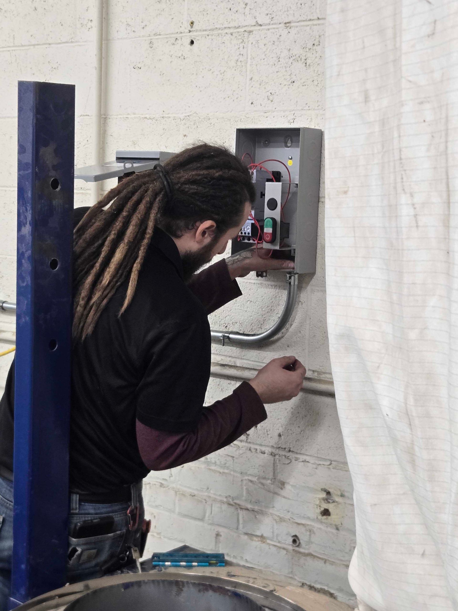Generac generator control panel with Emporia energy monitor installed on a dark wall.