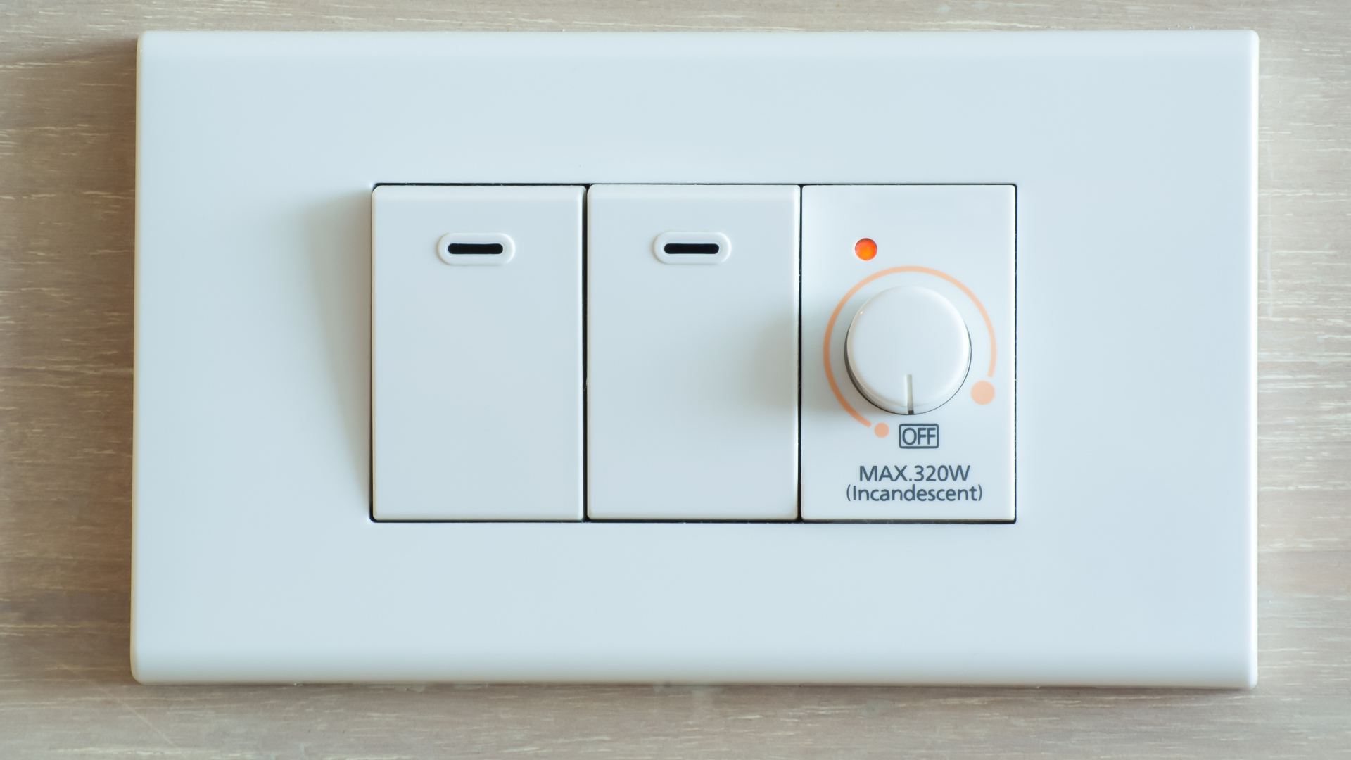 White light switch plate with two switches and one dimmer.