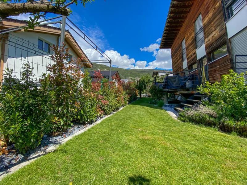 Il y a une grande pelouse devant une maison.