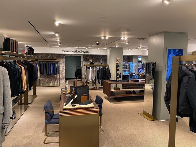 A large clothing store with a lot of clothes hanging on racks.