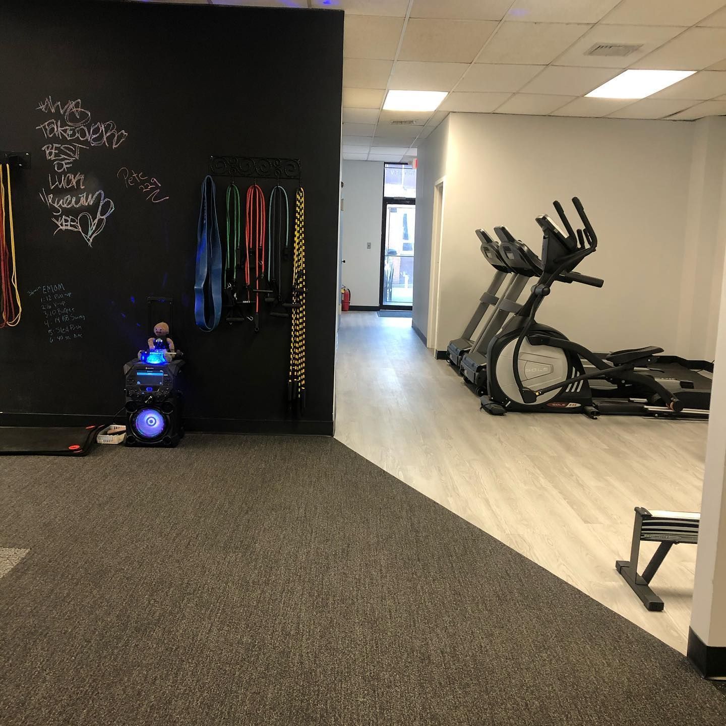 A gym with treadmills and an elliptical machine