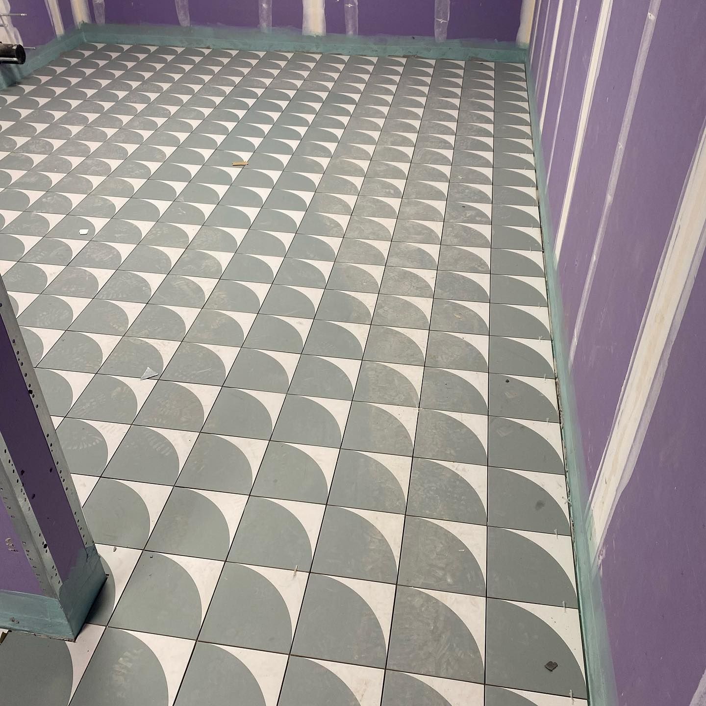 A gray and white tile floor with a geometric pattern