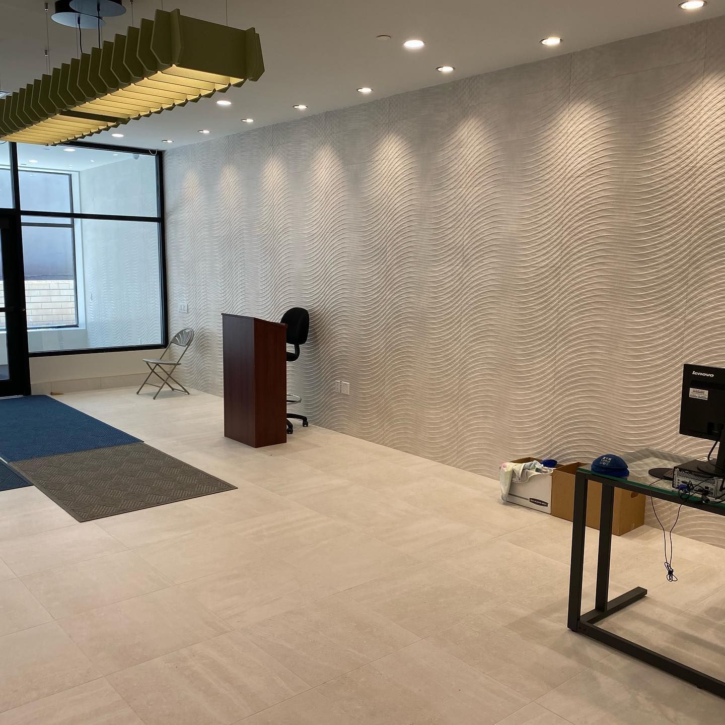 A room with a podium and a computer on a desk