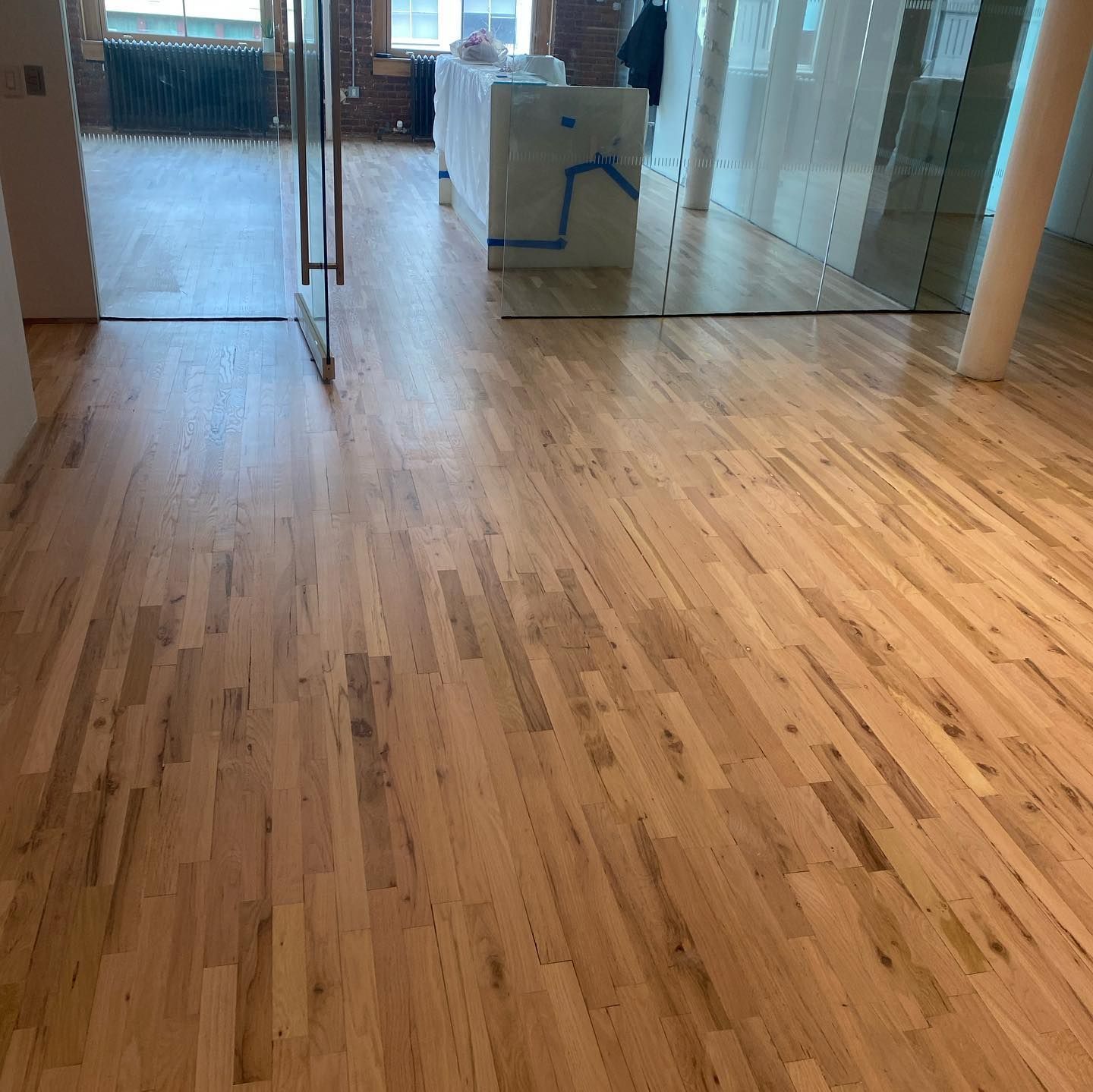 A room with a wooden floor and a glass door.