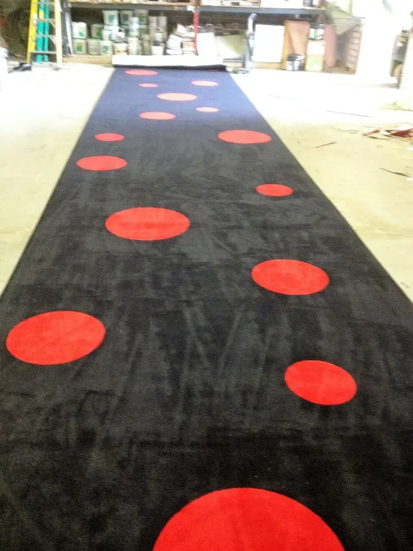 A black carpet with red circles on it