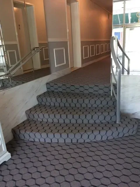 A hallway with stairs leading up to the second floor