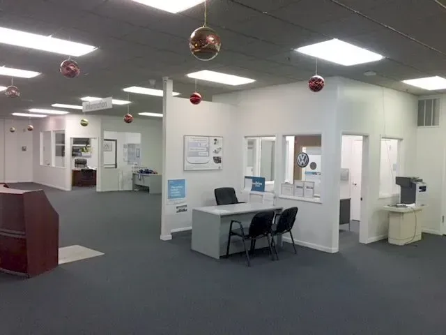 A large office with christmas decorations hanging from the ceiling