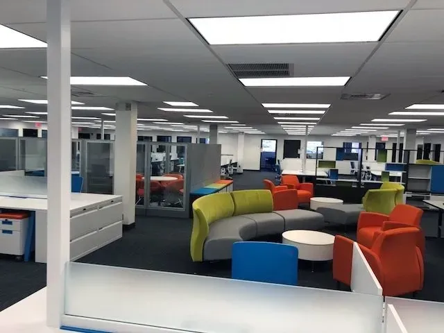 A large office with a lot of colorful furniture