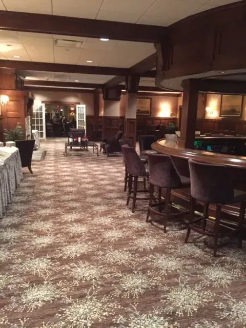 A large room with tables and chairs and a bar