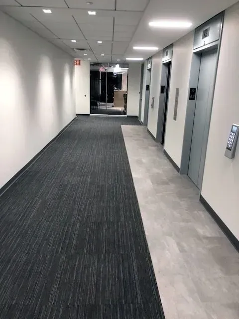 A long hallway with elevators on both sides of it