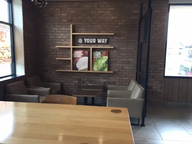 A restaurant with a sign on the wall that says your way