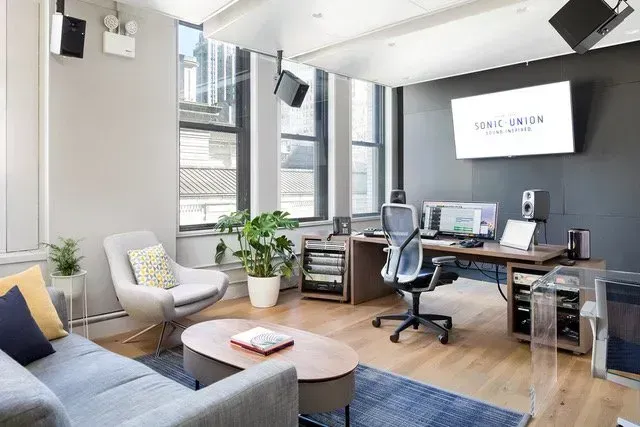 A bedroom with hardwood floors and a large bed