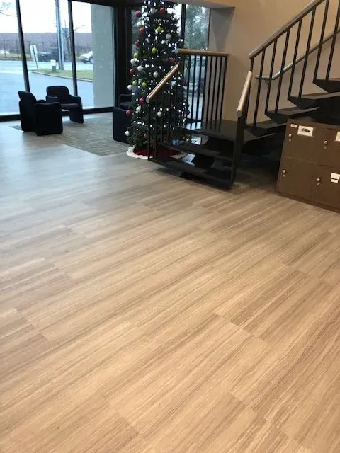 There is a christmas tree in the middle of the room.