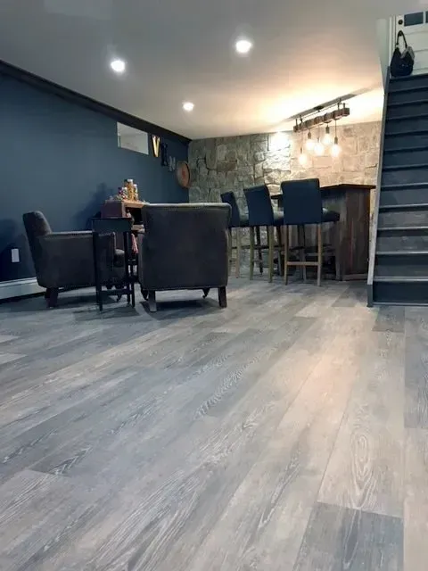 A living room with a wooden floor and stairs