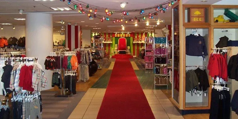The inside of a clothing store with a red carpet