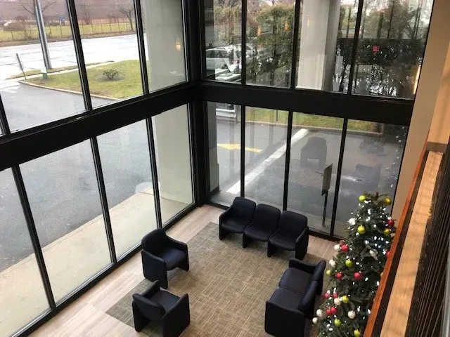 There is a christmas tree in the lobby of a building.
