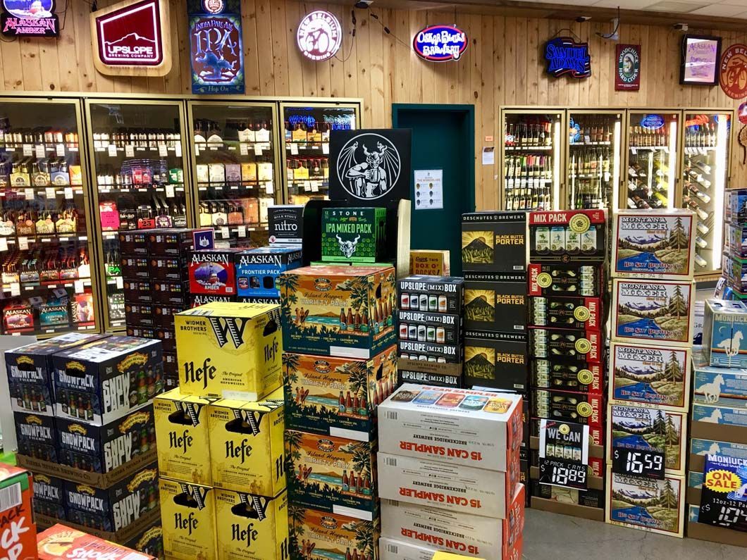 A liquor store filled with lots of boxes of beer.