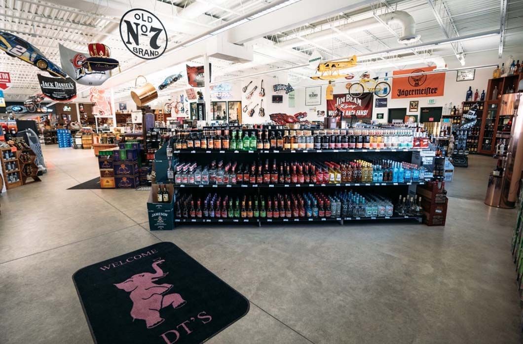A store filled with lots of bottles of alcohol and a welcome mat.