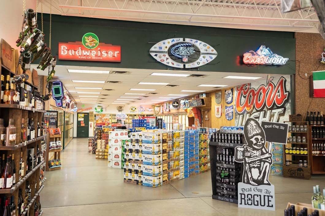The inside of a liquor store filled with lots of bottles of beer.