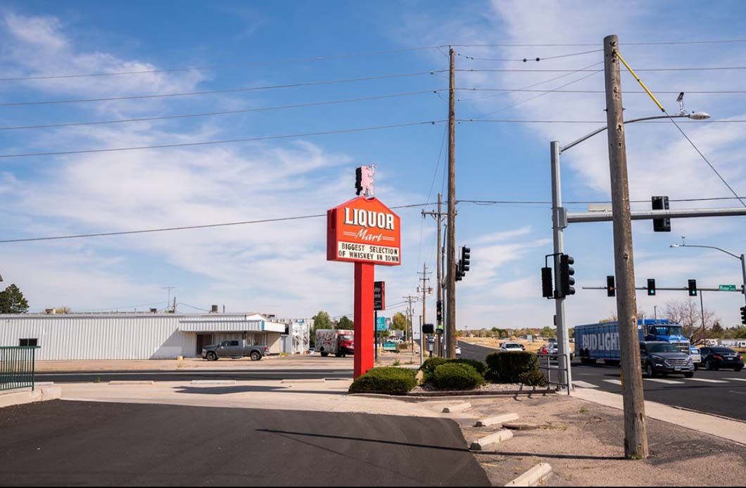 A red sign on a pole that says living on it