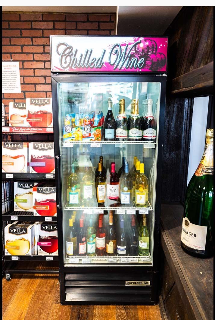 A refrigerator filled with bottles of chilled wine