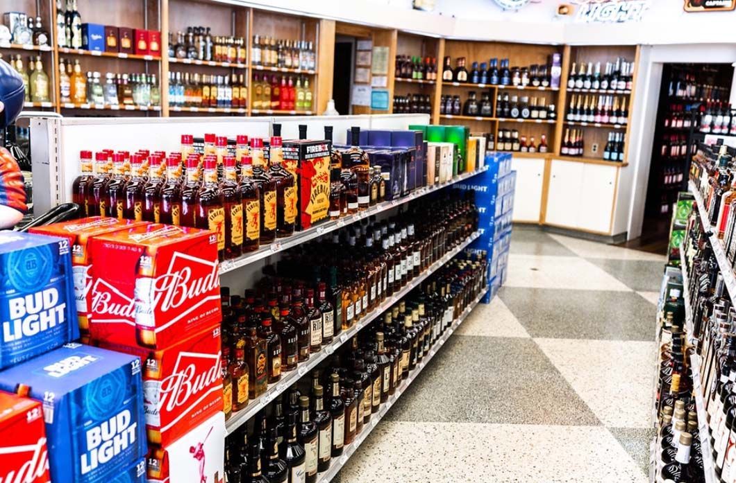 A liquor store filled with lots of beer and soda.