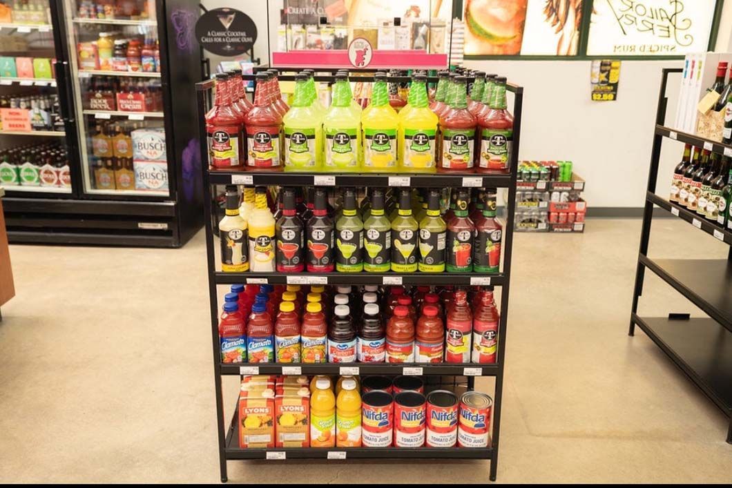 A shelf in a store filled with bottles of soda