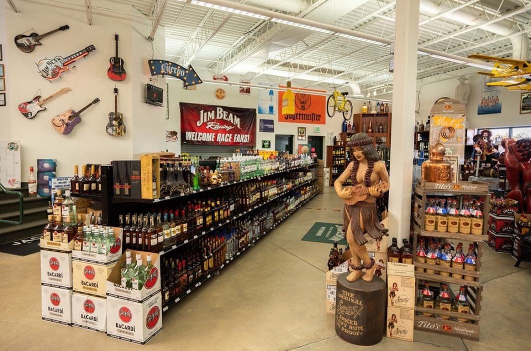 A liquor store filled with lots of bottles and a statue