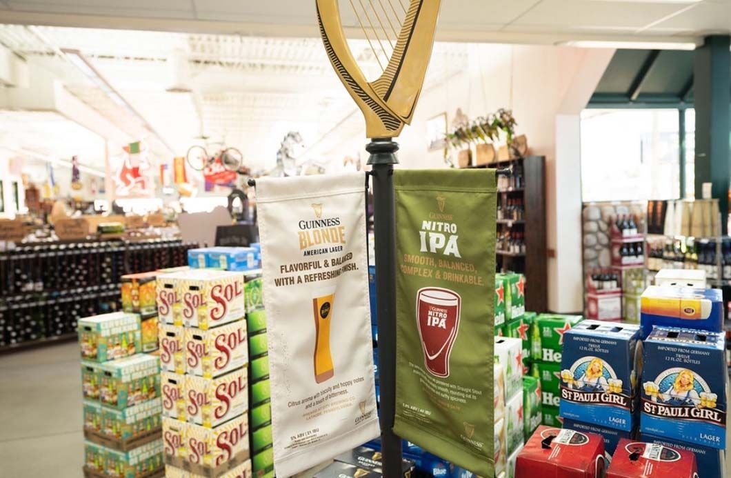 A store filled with lots of beer boxes and a harp.