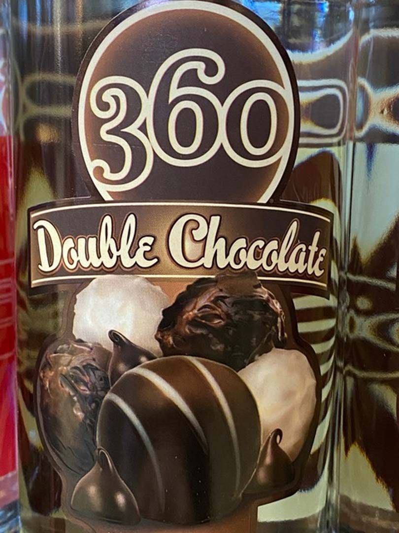 A glass of 360 double chocolate sitting on a table.