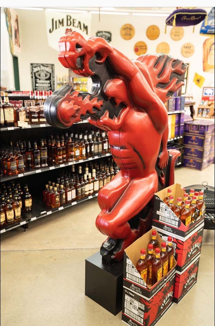 A statue of a devil in a liquor store